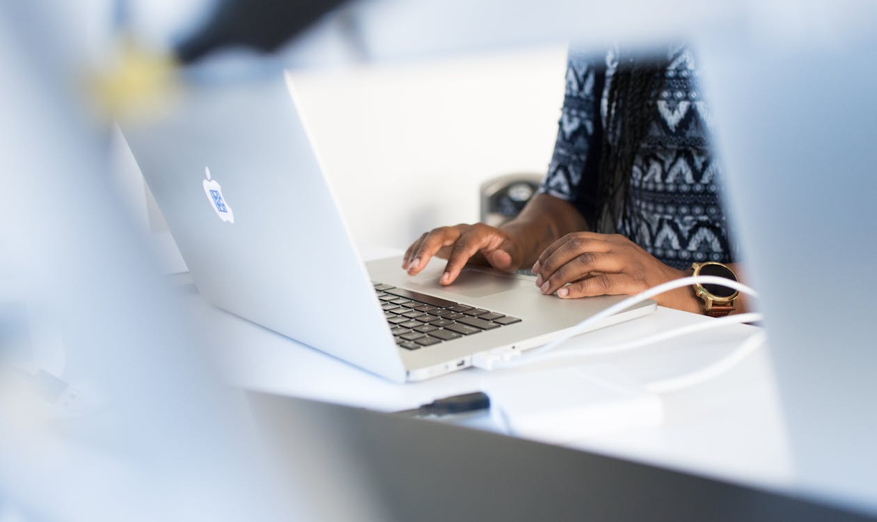 A professional working alongside AI tools at a desk
