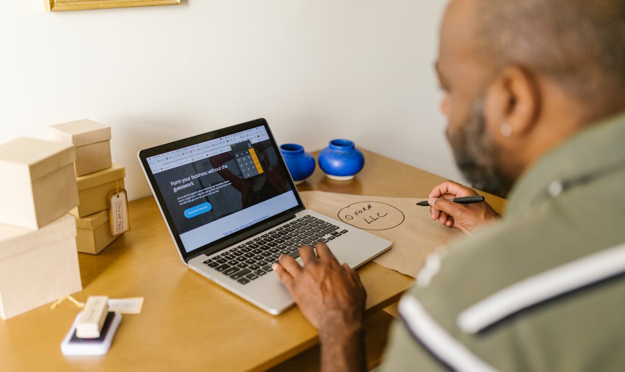 A small business owner using AI on their laptop