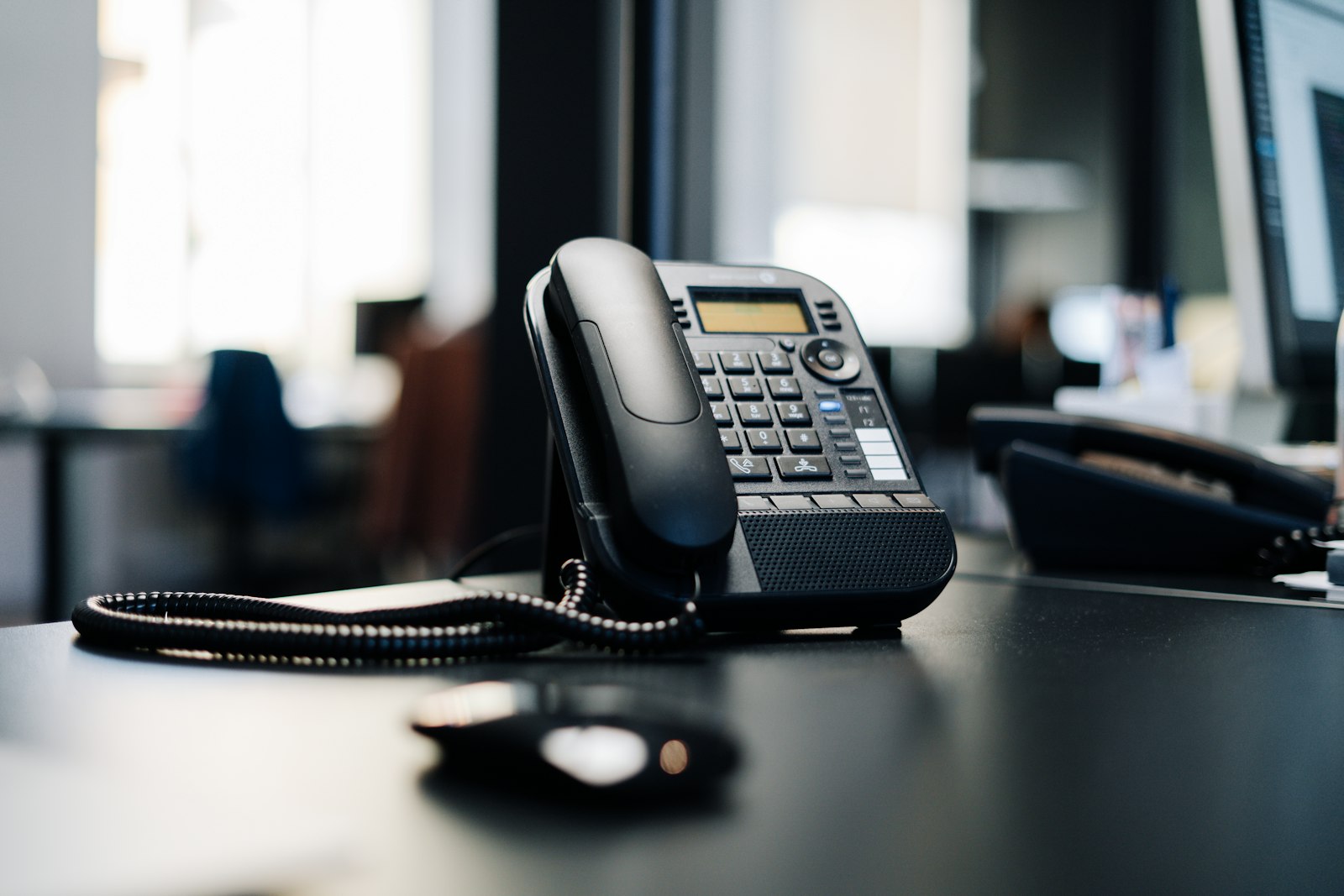 Vodafone and Google Cloud AI bundle for small businesses, desk phone on a wooden table